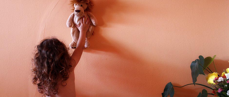 Djevojčica stavlja svog lava-igračku na zid | Girl Puts Her Lion Toy on the Wall